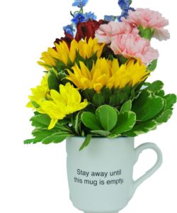mug full of colorful flowers with fun saying - "stay away until this mug is empty"