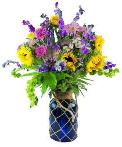 assorted yellow adn pink and purple flowers in vase