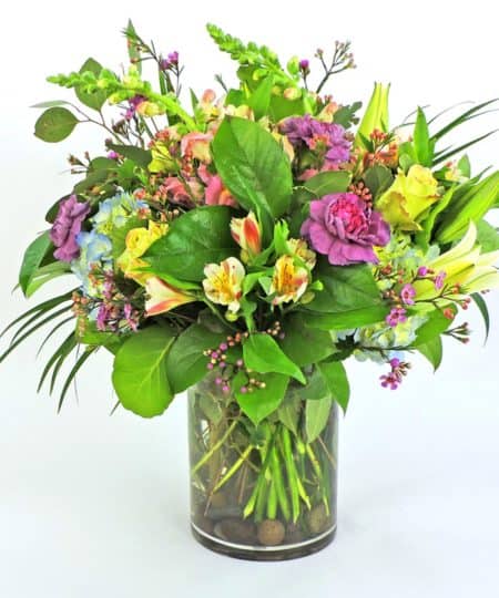 Modern compact soft colors feature hydrangea, roses and fragrant lilies. Stands just 20" high.
