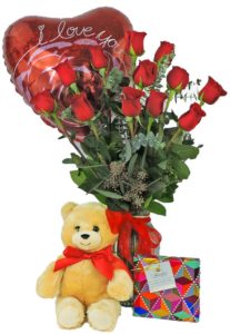 12 of our best red roses, designed in a clear glass vase, delivered with a cuddly bear